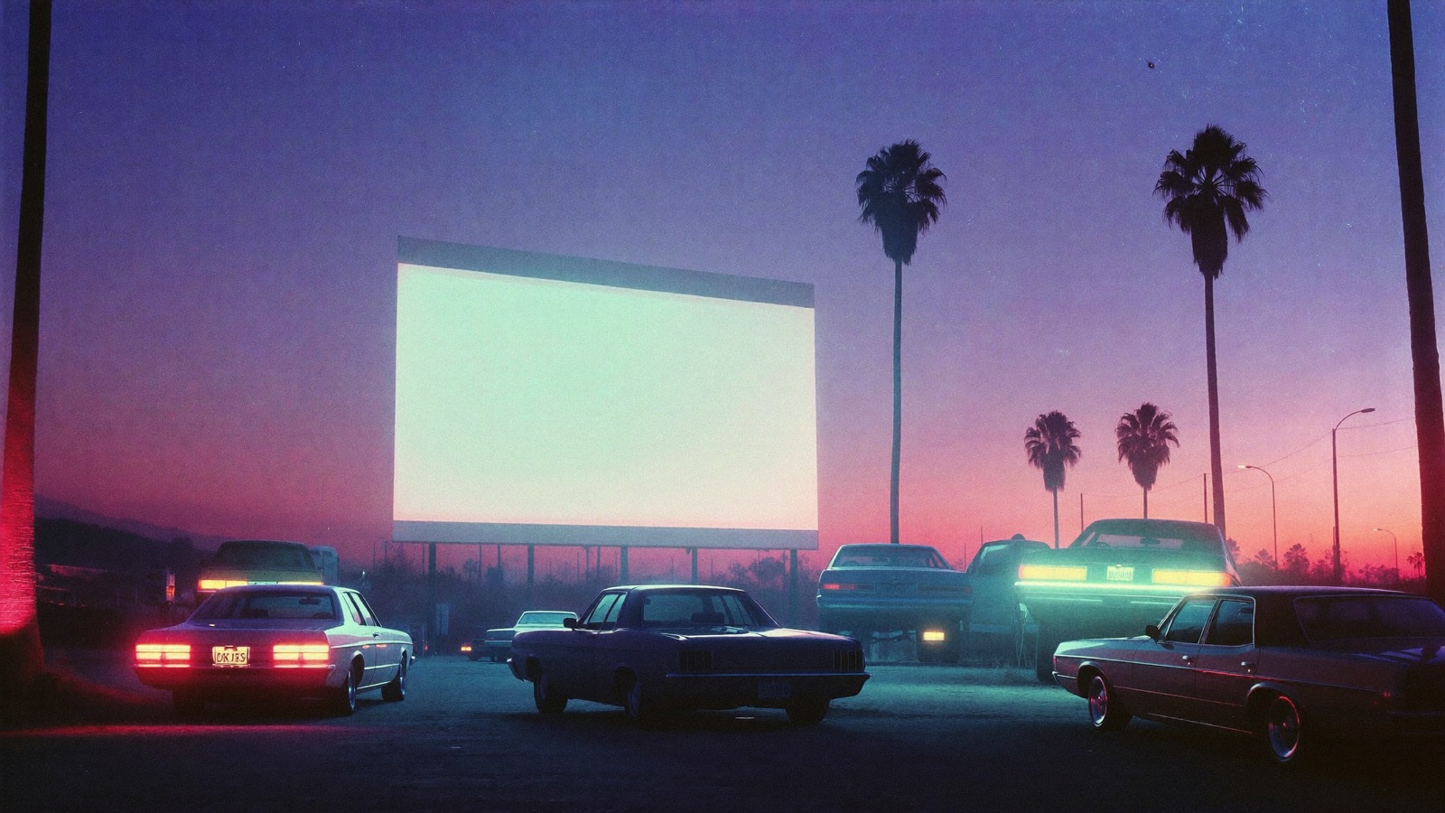 The Starlite Drive-In lot at night, palm trees in silhouette against a haze of pink and cyan neon light before the show.
